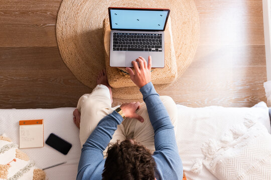 Anonymous man working on laptop at home