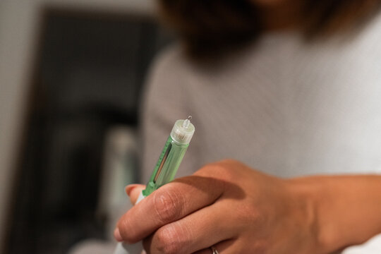 Woman checking insulin pen
