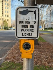 Crosswalk crossing post at an intersection with a shallow depth of field