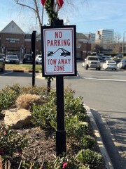 No Parking Tow Away Zone sign with a shallow depth of field