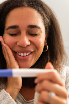 Joyful Moment of Surprise After Taking a Pregnancy Test at Home