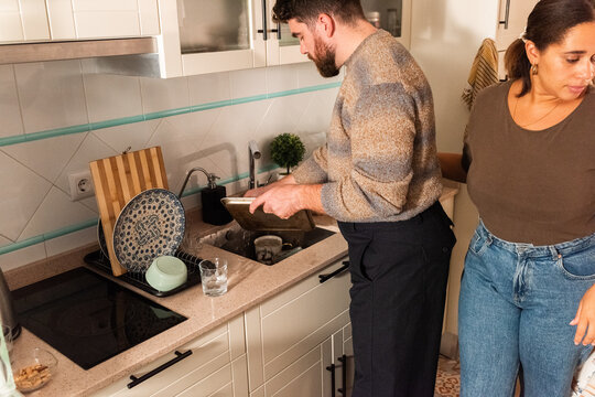Couple Washing Dishes Together in a Bright Modern Kitchen