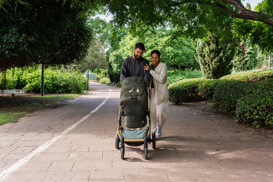 Couple pushing baby stroller 