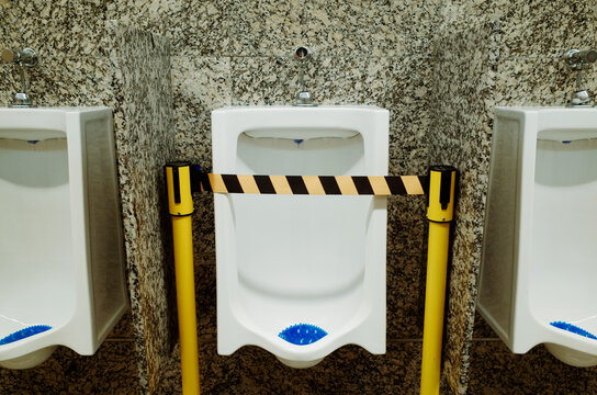 Urinals Blocked off for Maintenance in a Public Restroom Facility
