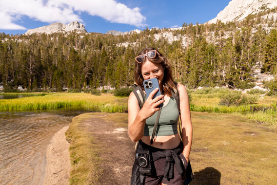 happy hiker holding mobile phone 