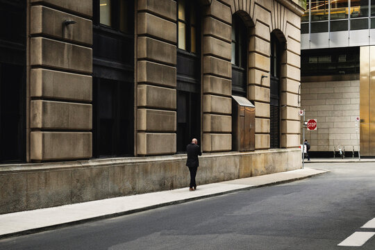 Lone pedestrian on city street