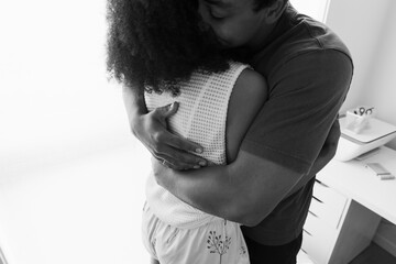 Caring hug between two people in warm black and white