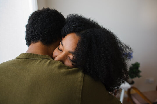 Caring embrace between friends, a comforting hug at home