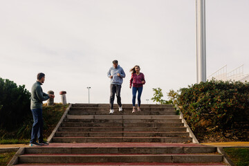 Geriatric trainer monitoring the activity of an elderly couple