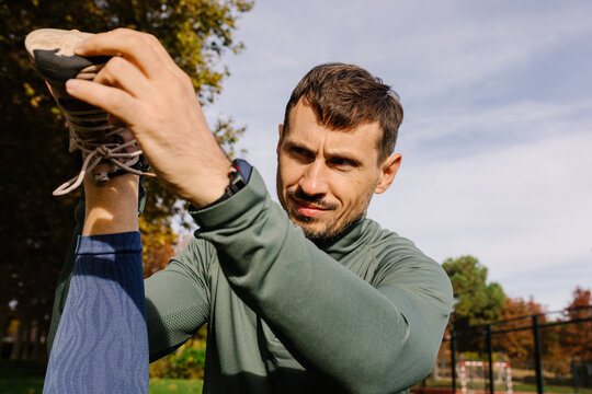 Geriatric trainer monitoring the flexibility of an elderly woman