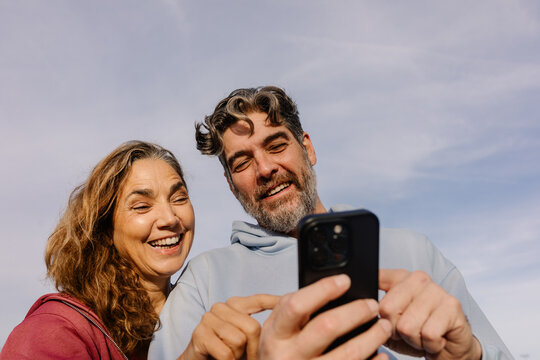 Elderly people spending quality time together using a cell phone