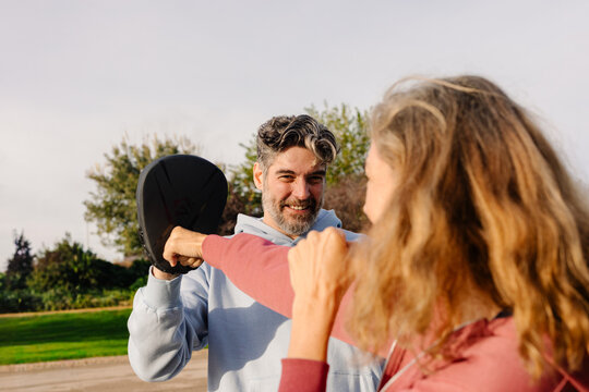 Active older couple training martial arts together