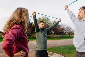 Senior wellness trainer energizes an active older couple