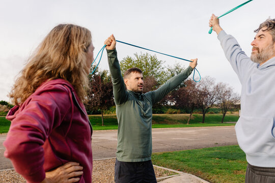 Senior wellness trainer energizes an active older couple