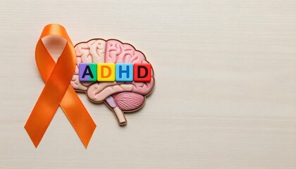 Image of a brain and orange ribbon on a wooden backdrop, emphasizing ADHD awareness, neurodiversity, and mental health