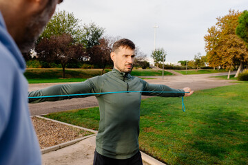 Geriatric therapist showing an older couple how to perform exercises