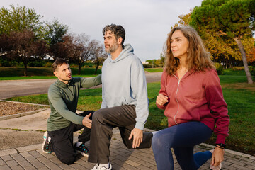Full-length view of senior fitness expert supervising elderly couple