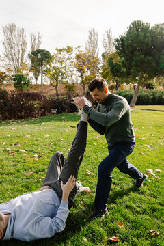 Trainer specializing in elderly health examines a senior man
