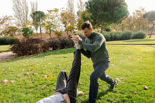 Trainer assisting mature adult as part of a healthy lifestyle routine