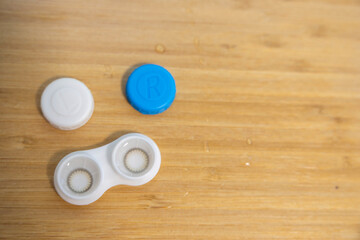 Contact Lenses and Case on a Table with Copy Space