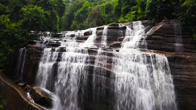 Aerial drone of Waterfall in the tropical mountain jungle. Olu Ella Falls, Sri Lanka.