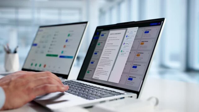 Man Using Online Document Management Software To Store Contracts