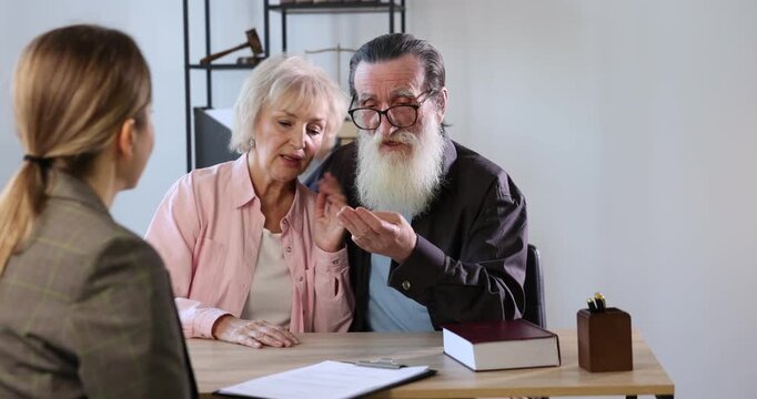 Notary consulting senior couple about Last Will and Testament in office