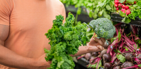 Healthy eating. Fresh food store. Man in grocery store. Man shopping in vegetable supermarket....