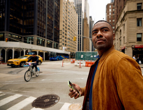 Man stands on the corner in downtown