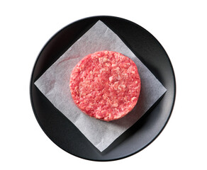 black plate with raw ground beef patty for hamburgers isolated on white background, top view.