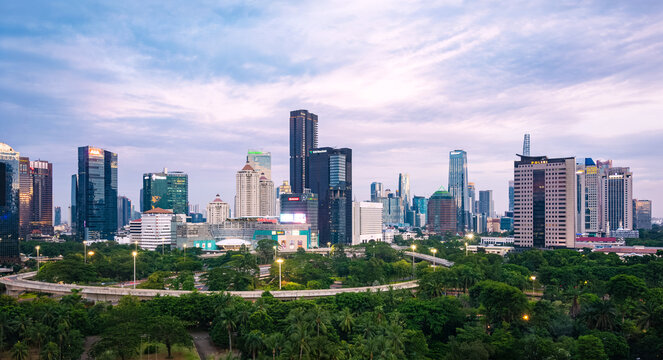 Jakarta, Indonesia - 1 Jan 2022: View of Jakarta's Central Business District cityscape at sunset. Simpang Susun Semanggi (Semanggi Interchange) is also visible.