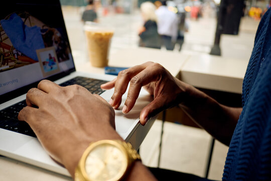 Detail of a man works on a laptop in downtown