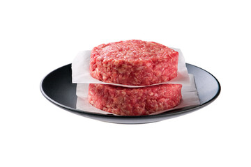 Raw minced beef patties for hamburgers in a black bowl isolated on white background.