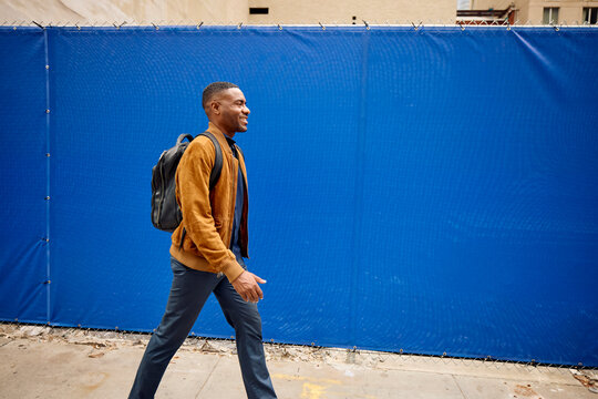 Smiling man walks in town