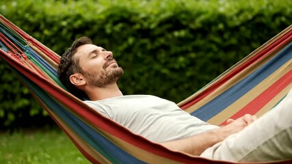 World Sleep Day - Relaxed man napping peacefully in a vibrant striped hammock in a lush green garden, enjoying tranquil outdoor leisure and stress relief.