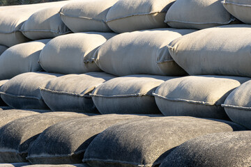 Stacked sandbags used for erosion control and flood mitigation along a developed shoreline or infrastructure edge in Australia. Protective engineering for environmental protection