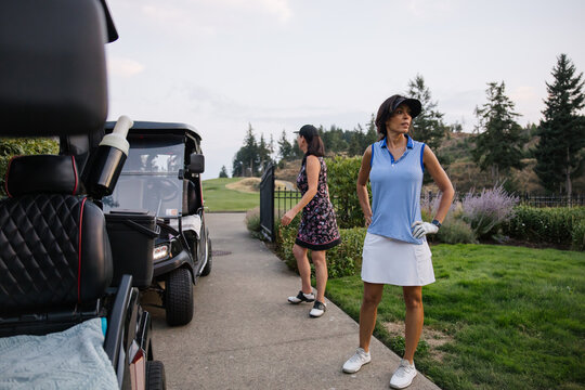 Candid scene of women at a golf course, ready for play