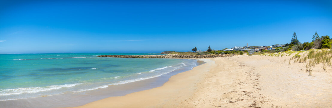 Panoramic view of the beach in Beachport South Australia. The ocean is calm on a sunny summer day and the place is empty 