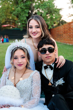 Newlyweds with Family Member on Wedding Day