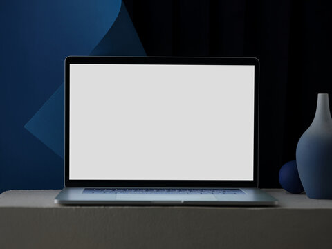 Laptop with blank screen on a modern desk with blue background