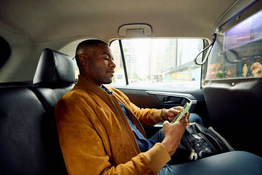 Passenger uses the phone in taxicab