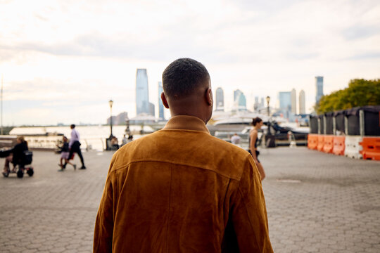 Mman walks on the riverside promenade