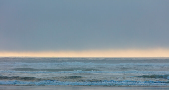 Lifting fog over ocean at dusk