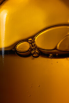 Transparent Liquid With Bubbles in a Glass Amber Dropper Bottle. 