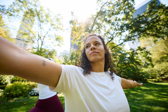Women practice yoga in the park