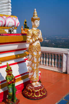 White and gold Thepanom angel statue at Wat Phra That Doi Kham temple on the mountain side of Chiang Mai, Northern Thailand