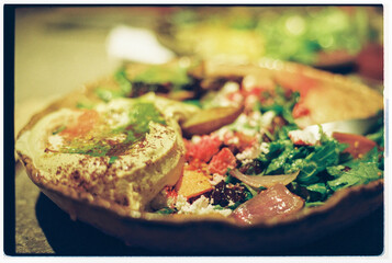 Delicious Salad and Hummus Plate Served in a Rustic Setting
