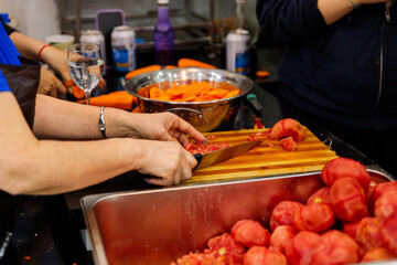 Senior Woman Chopping Fresh Tomatoes and Carrots for Cooking