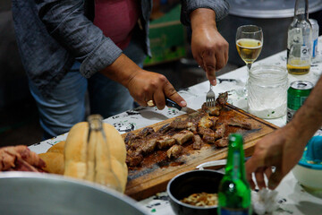Man Sharing Grilled Meat During a Casual Gathering