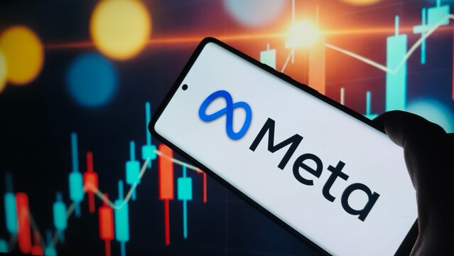 Meta logo on smartphone screen with stock market graph background